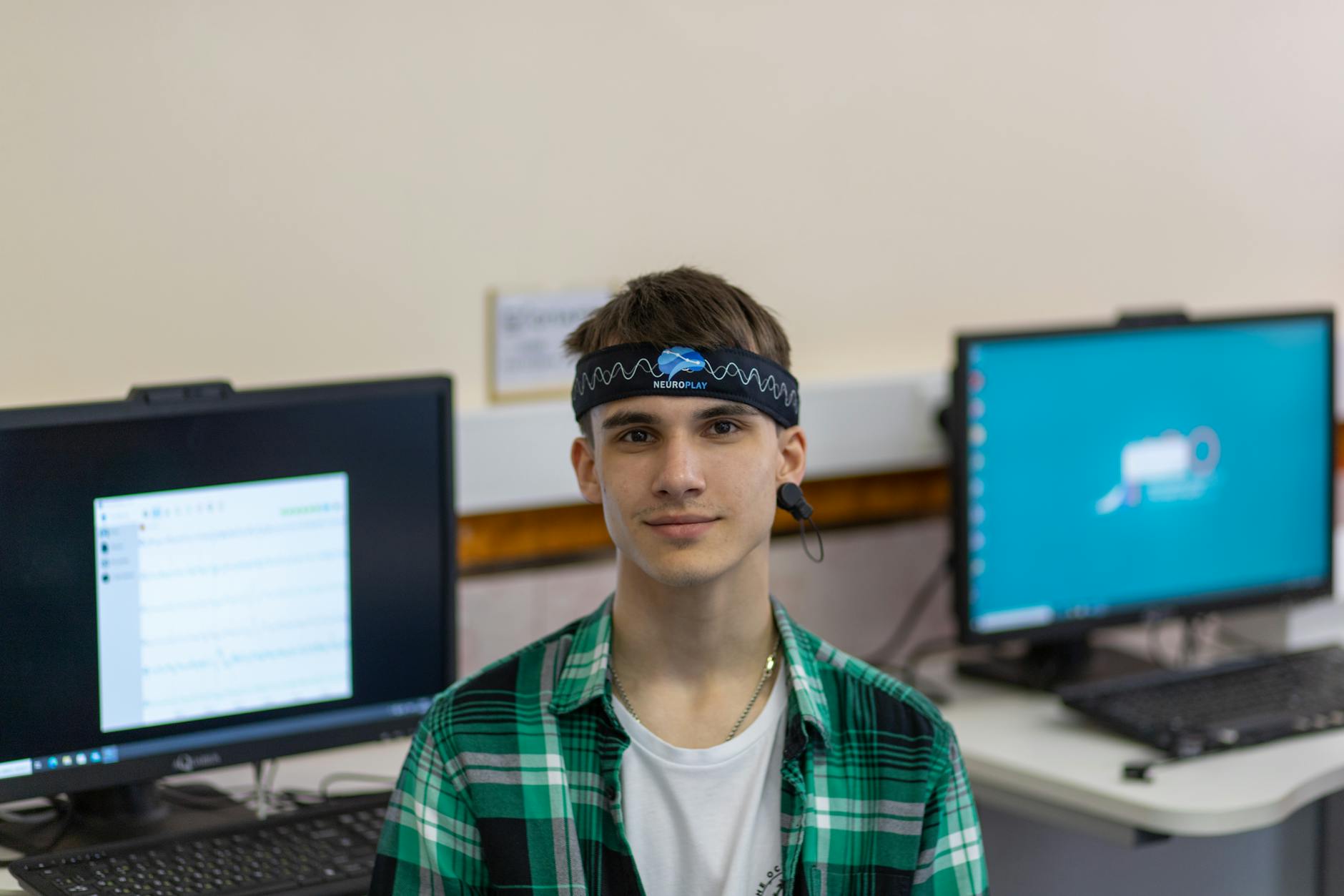 young man in plaid dress shirt wearing black sweatband