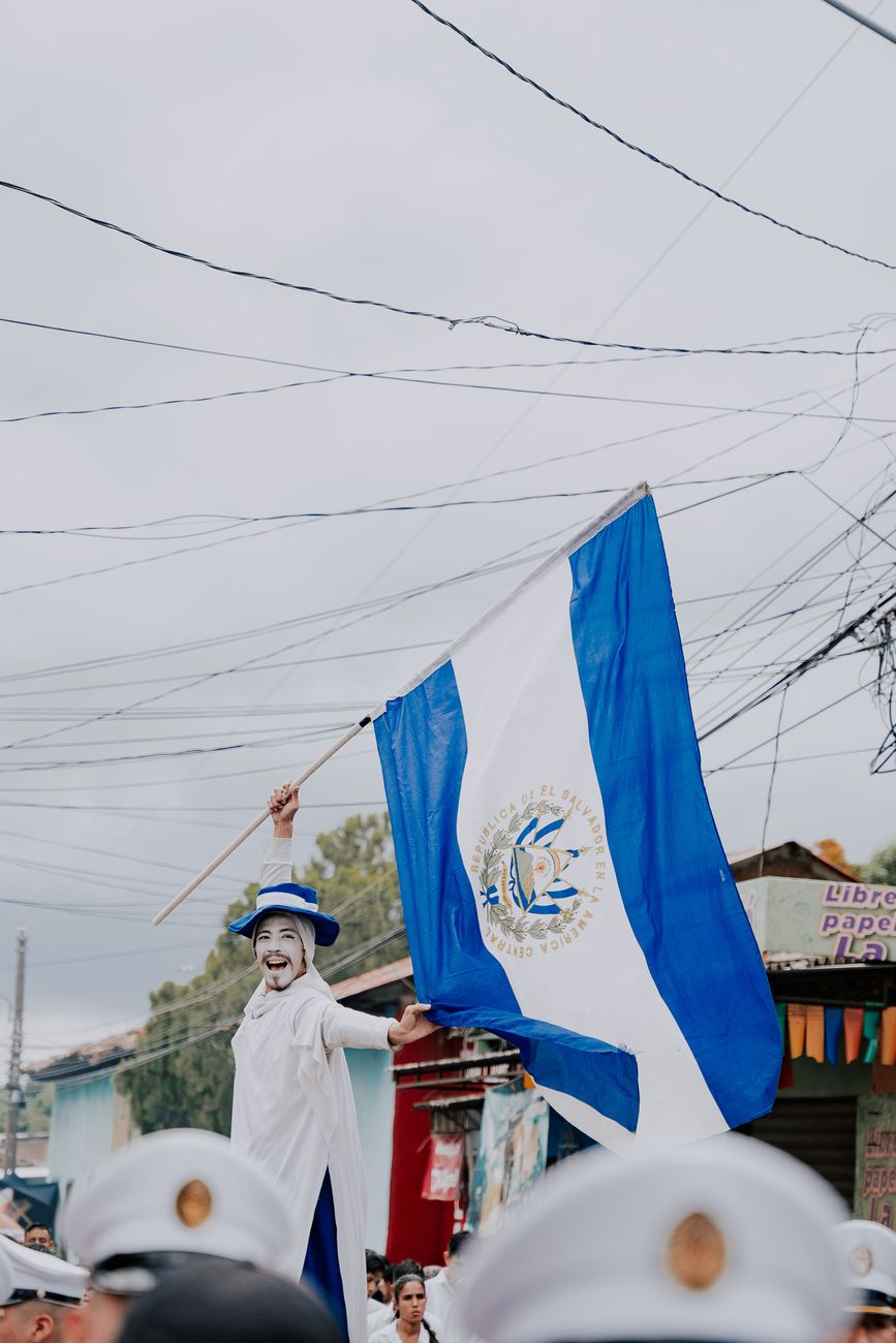 man holding a guatemala flag on a parade
